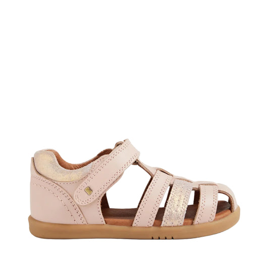 Pink sandal with brown sole on a light gray background