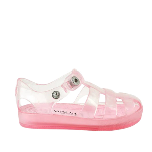 Pink jelly sandal with clear sole on a white background