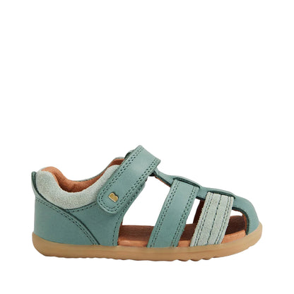 Green sandal with brown sole on a light gray background