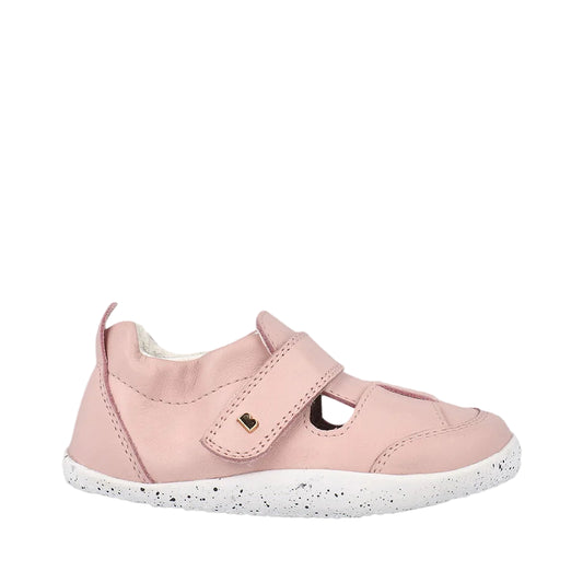 Pink children's shoe with a white sole on a light gray background