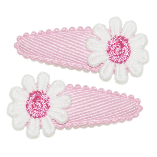 Two pink hair clips with white daisy flowers on a white background