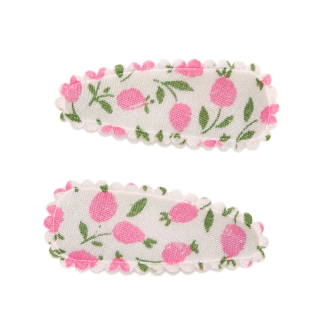 Two floral hair clips on a white background