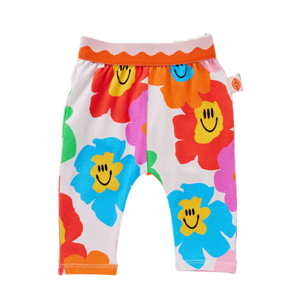 Colorful children's pants with smiley face flowers on a white background