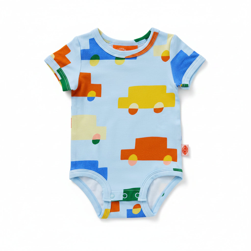 A baby short-sleeve bodysuit in light blue with a colorful pattern of cartoon cars and geometric shapes in orange, yellow, green, and blue, shown on a white background.