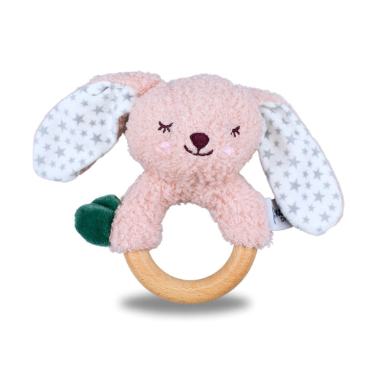 Pink bunny plush toy with wooden ring on a white background