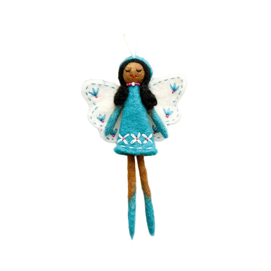 Felt fairy doll with blue dress and white wings hanging on a wooden stick against a rustic wooden background.