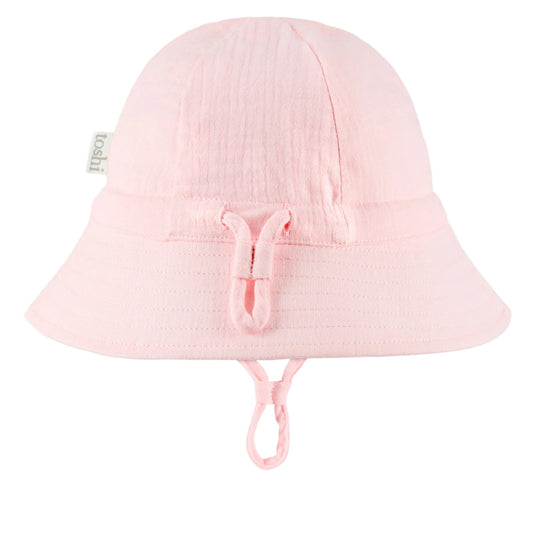 Pink sun hat with UPF 50+ label on a white background