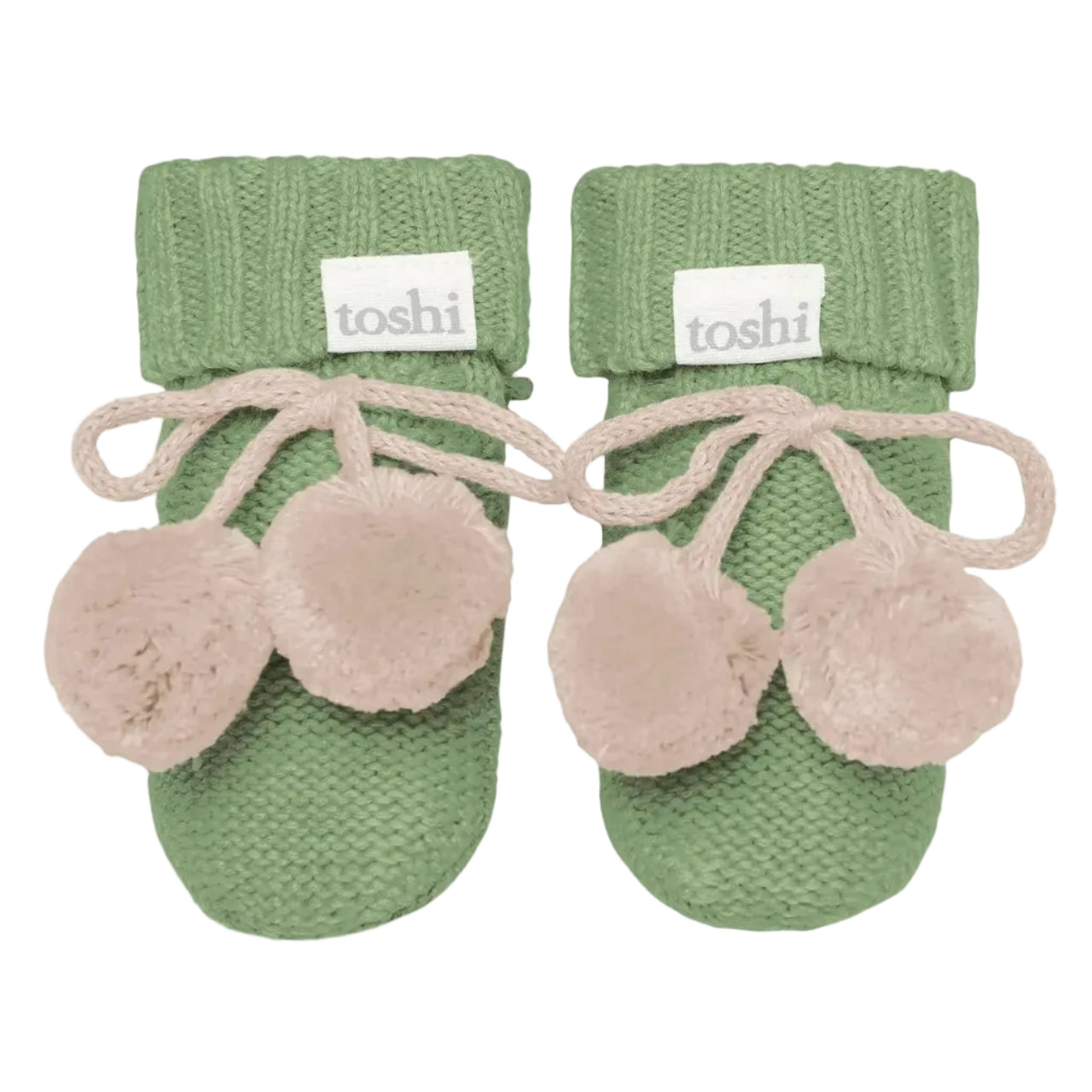 Pair of green baby booties with beige pom-poms on a white background, featuring the brand 'toshi'.