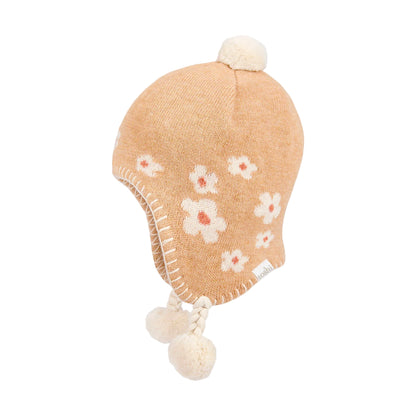 Knitted baby hat with floral patterns and pom-poms on a light gray background