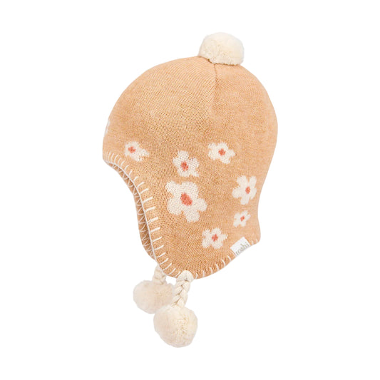 Knitted baby hat with floral patterns and pom-poms on a light gray background