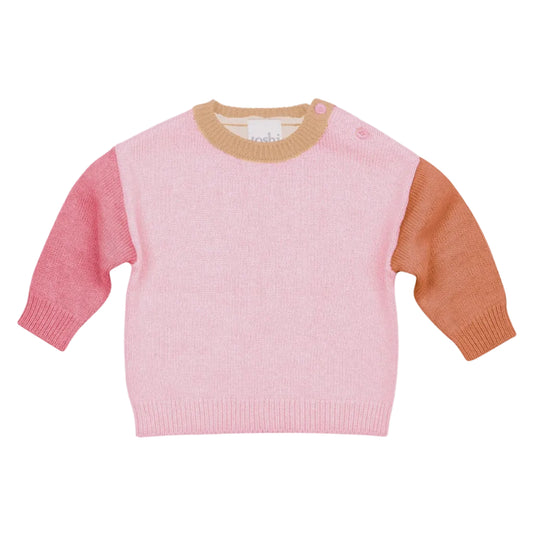 Pink sweater with brown sleeves on a light gray background