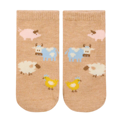 Pair of socks with farm animal pattern on a beige background