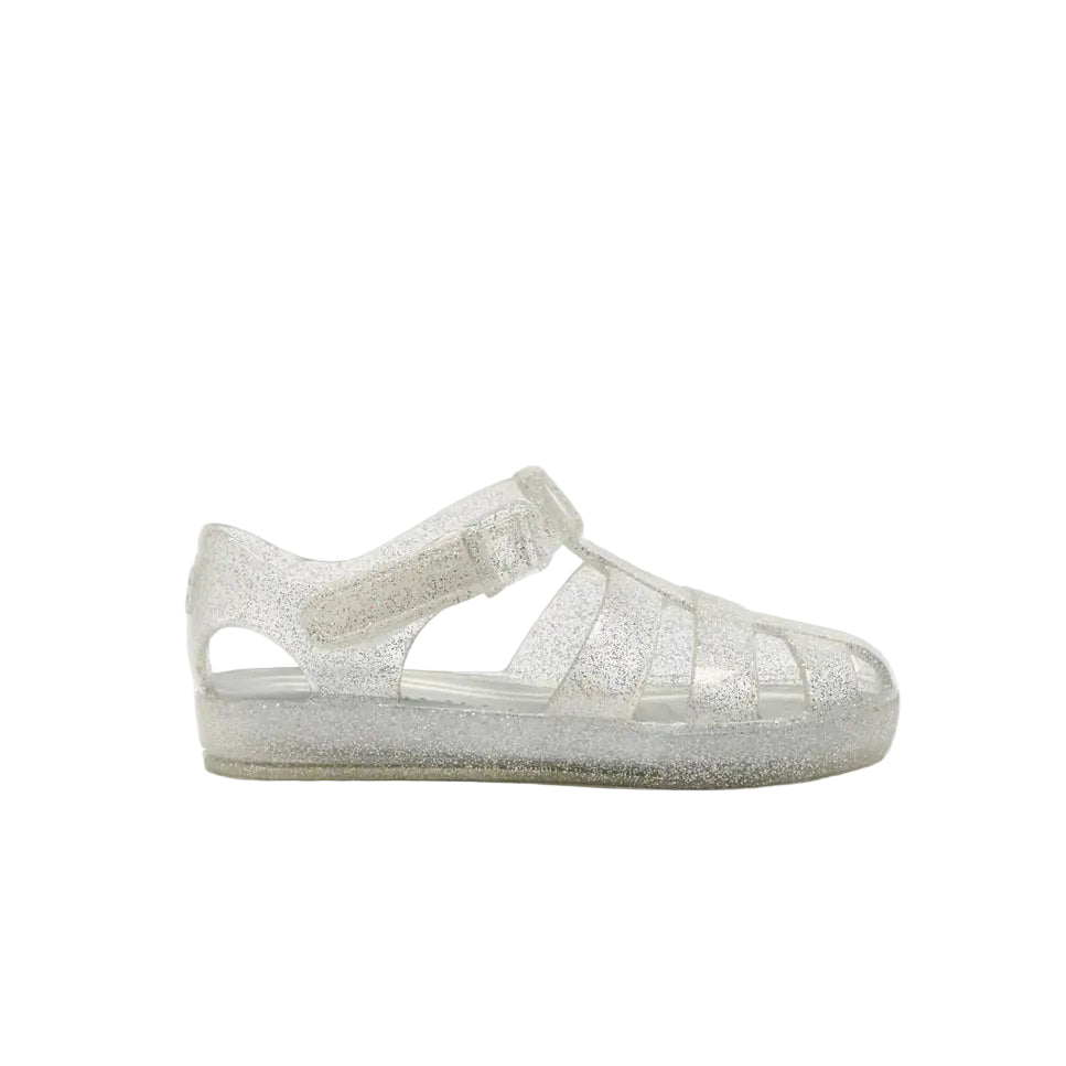 A single silver glitter jelly sandal for toddlers, shown from the side against a plain white background.
